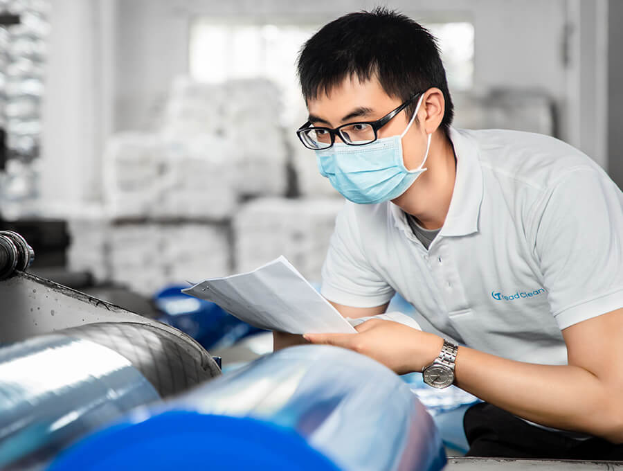 worker inspecting the cutting machine functioning